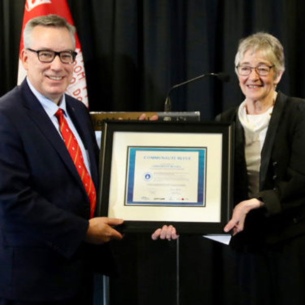 Yves Beauchamp, Vice Principal, Administration and Finance, accepts McGill’s Communauté bleue certificate