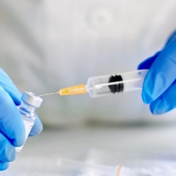 Scientist using a seringe